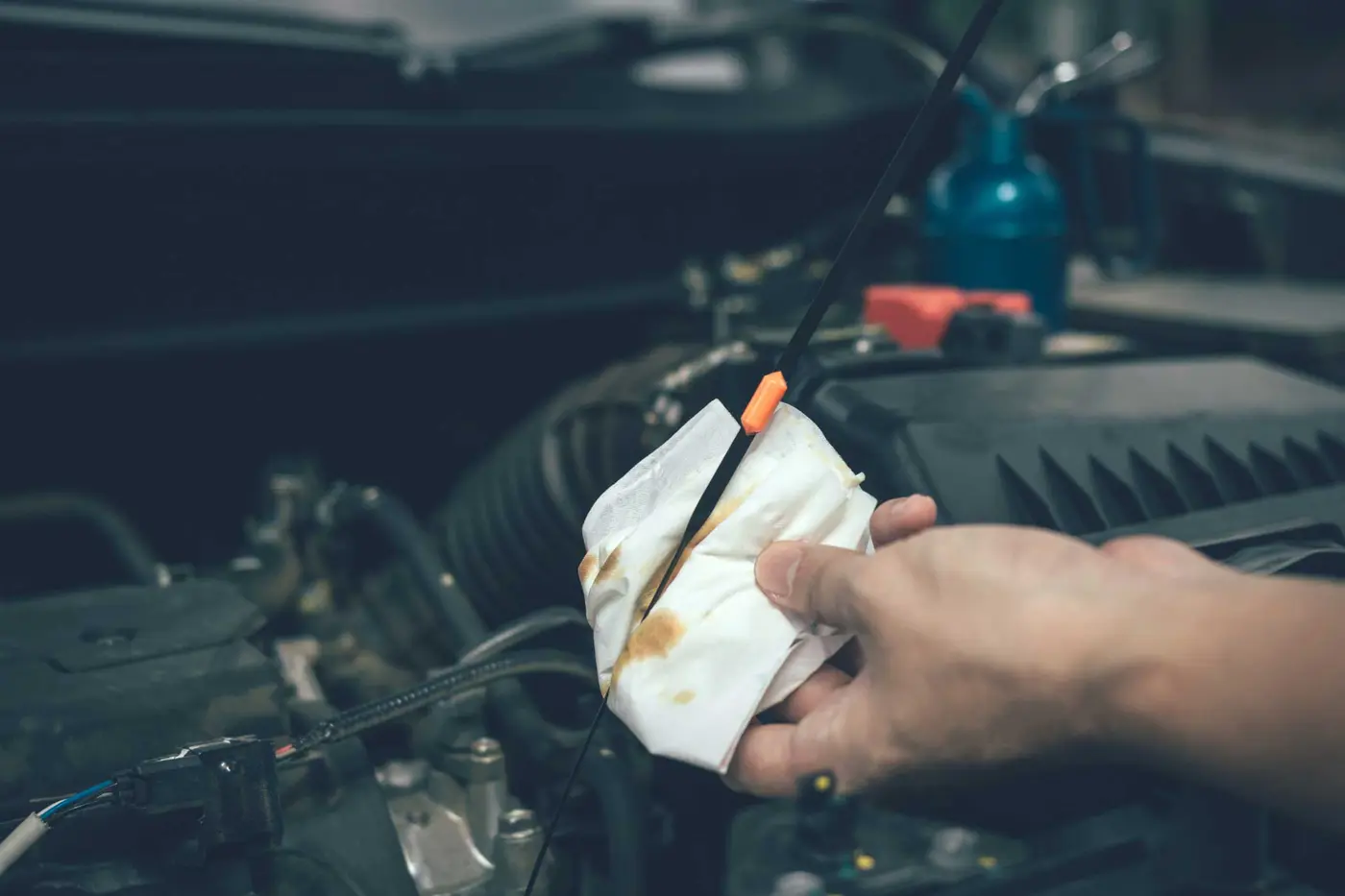 Mechanic carrying out an engine check during a car service at C.A.M.S. Chippenham